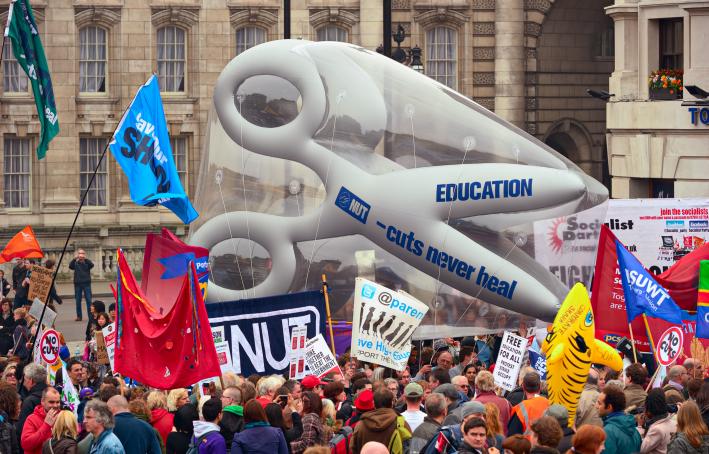 Protesters march past Trafalgar Square against public expenditure cuts in a rally -- March for the Alternative -- organised by the Trades Union Congress (TUC) in London, 2011