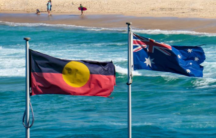 The Australian flag and Australian Aboriginal flag fly side-by-side at Bondi Beach, Sydney