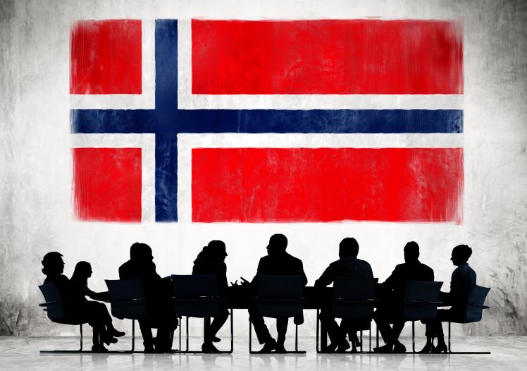 Business People in a Meeting with Norwegian Flag