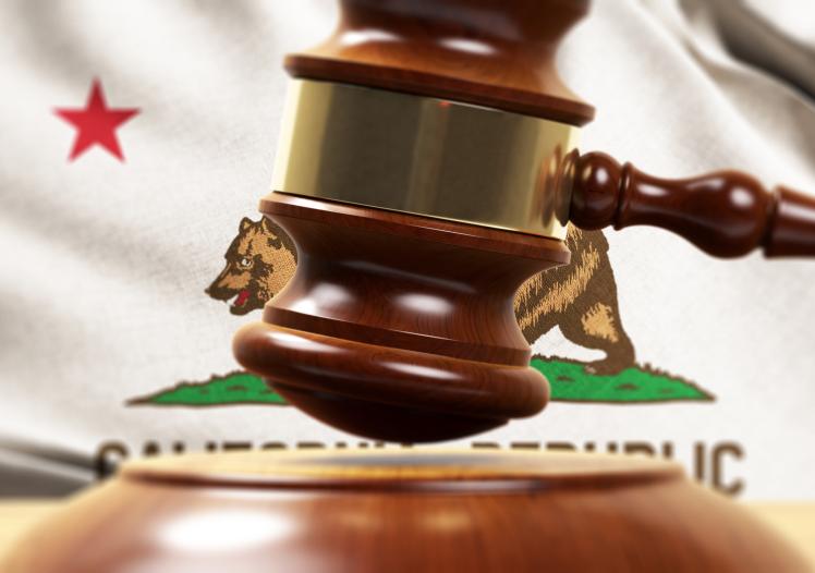 Wood Gavel Standing Front Of the California State Flag 