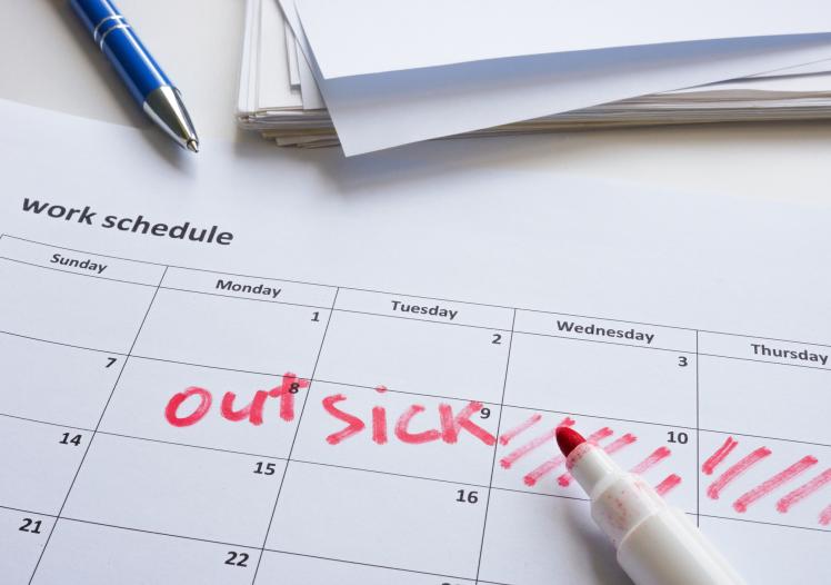 Red markig crossing days off a calendar for sick leave 