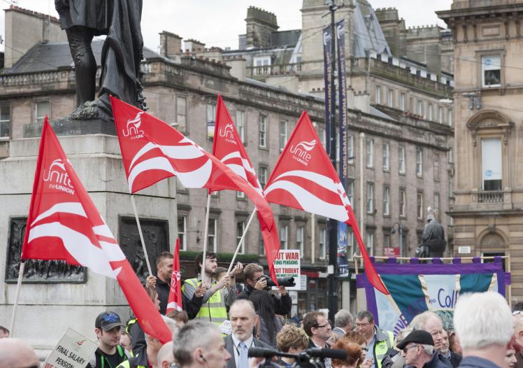 Red Unite the Union flags held by demonstrators in Glasgow 