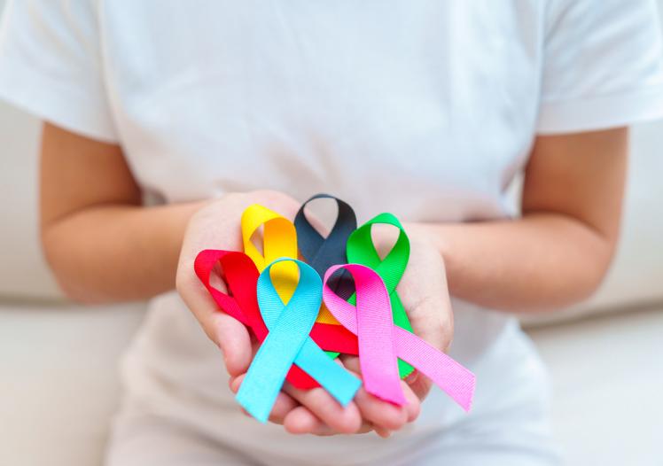 Woman holding cancer awareness ribbons