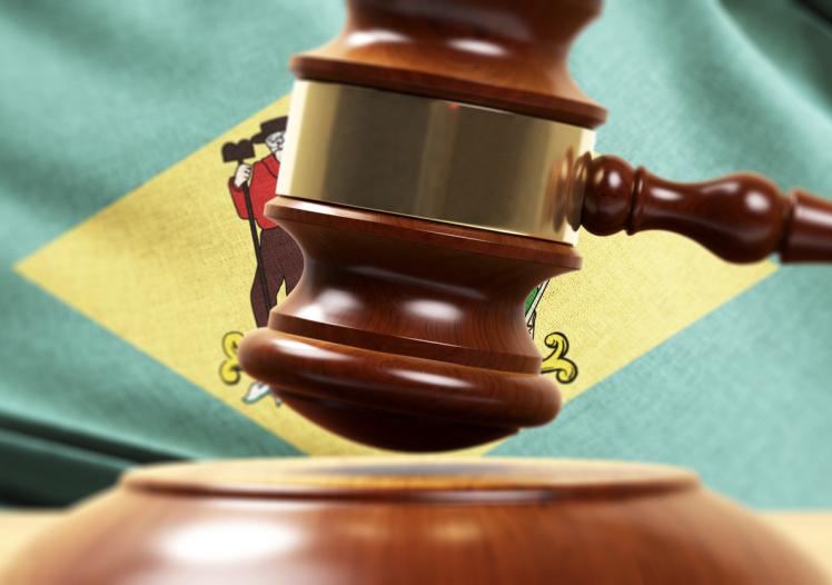 Wood Gavel Standing Front Of the Delaware State Flag