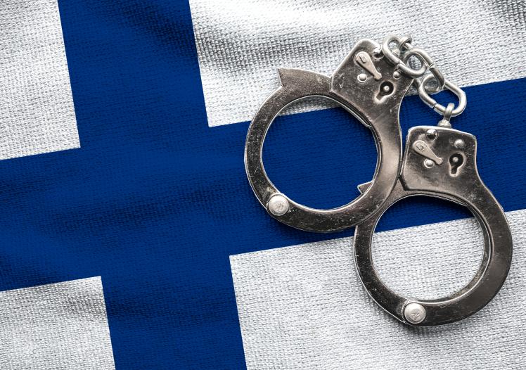 Flag of Finland and police handcuffs