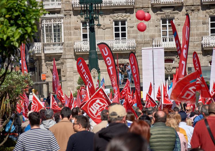 Labor Day demonstration with red flags during May 1st rally in Vigo, Spain