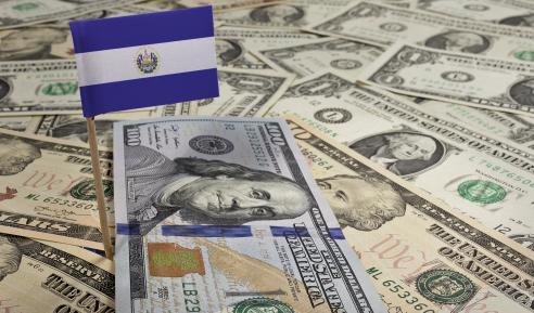 Flag of El Salvador sticking in various american banknotes
