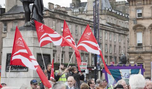 Red Unite the Union flags held by demonstrators in Glasgow 
