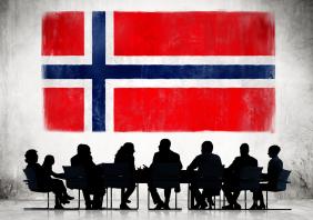 Business People in a Meeting with Norwegian Flag