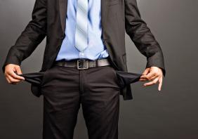 Business man showing his empty pockets