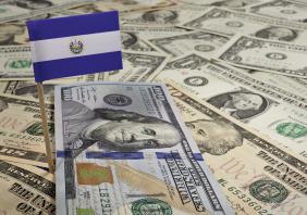Flag of El Salvador sticking in various american banknotes