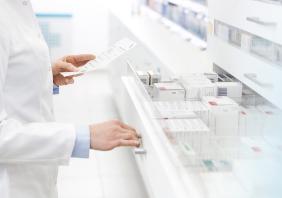 Pharmacist finding drug prescription 