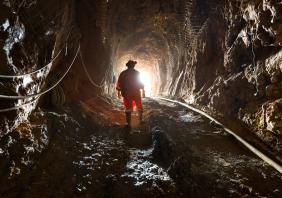 Miner inside the access tunnel of an underground gold and copper mine