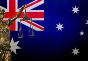 Lady Justice before an Australian flag 