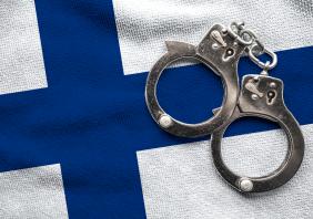Flag of Finland and police handcuffs