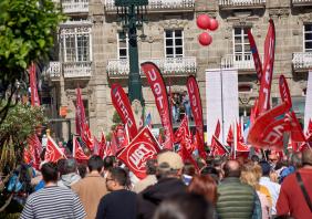 Labor Day demonstration with red flags during May 1st rally in Vigo, Spain