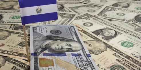Flag of El Salvador sticking in various american banknotes