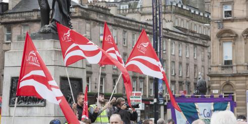 Red Unite the Union flags held by demonstrators in Glasgow 