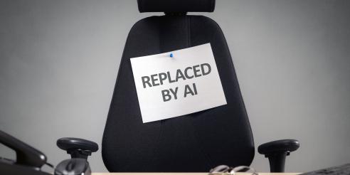 Empty office chair with replaced by AI sign
