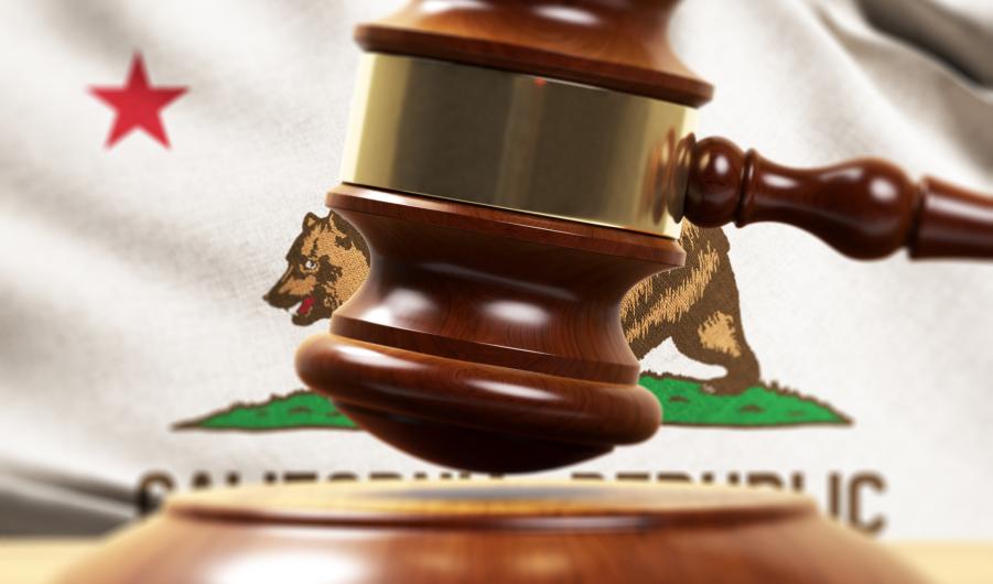 Wood Gavel Standing Front Of the California State Flag 