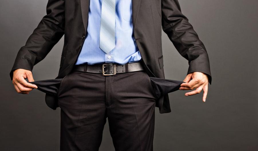 Business man showing his empty pockets