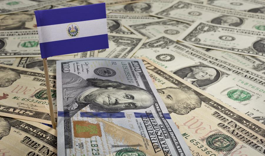 Flag of El Salvador sticking in various american banknotes