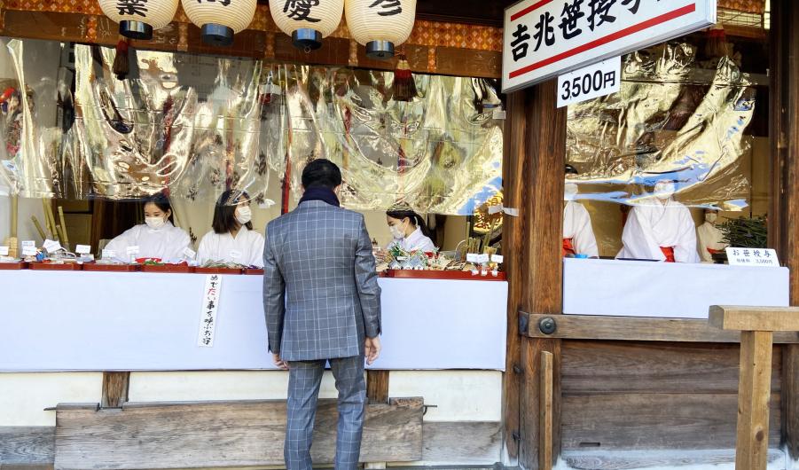 Businessman buying a Fuku-Zasa - a type of bamboo 