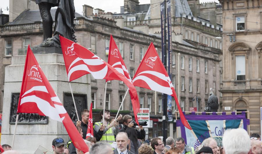 Red Unite the Union flags held by demonstrators in Glasgow 