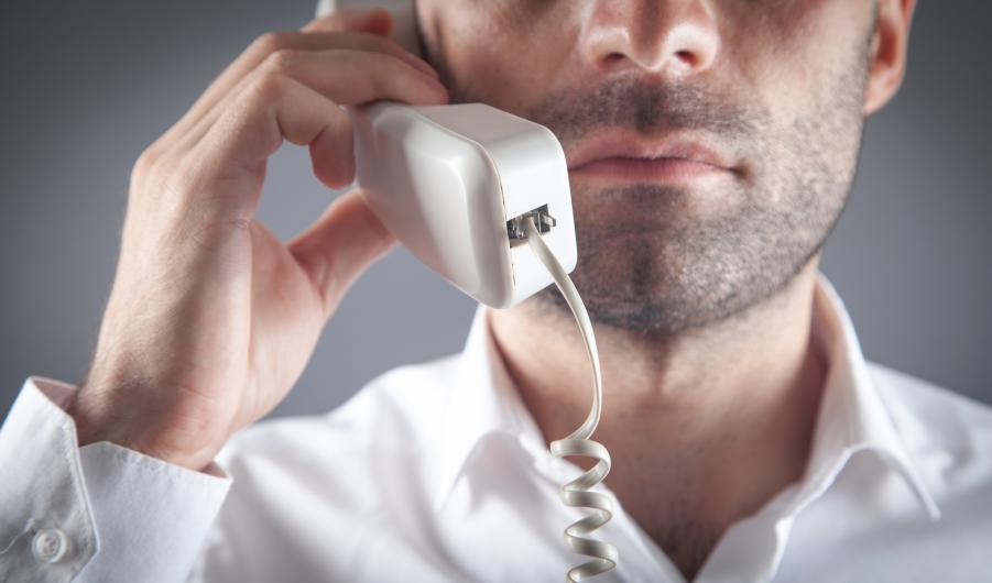 man talking on office telephone