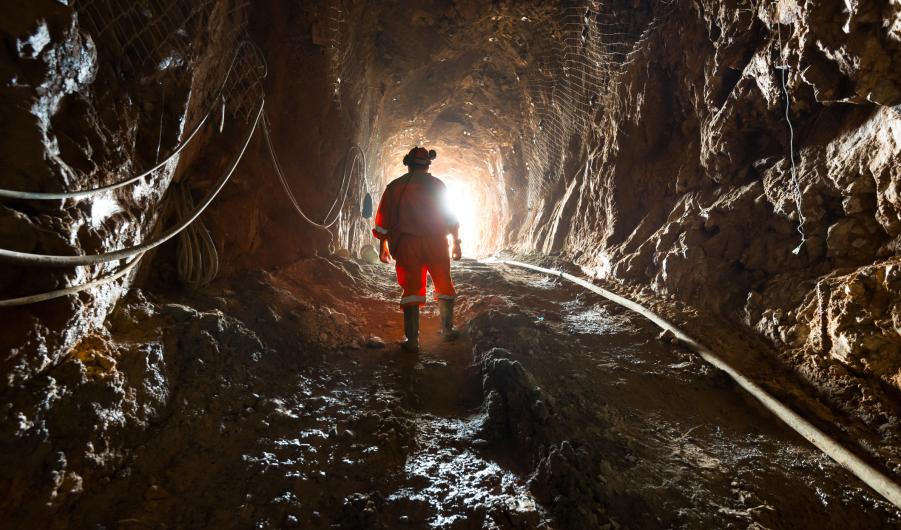 Miner inside the access tunnel of an underground gold and copper mine