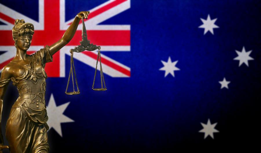 Lady Justice before an Australian flag 