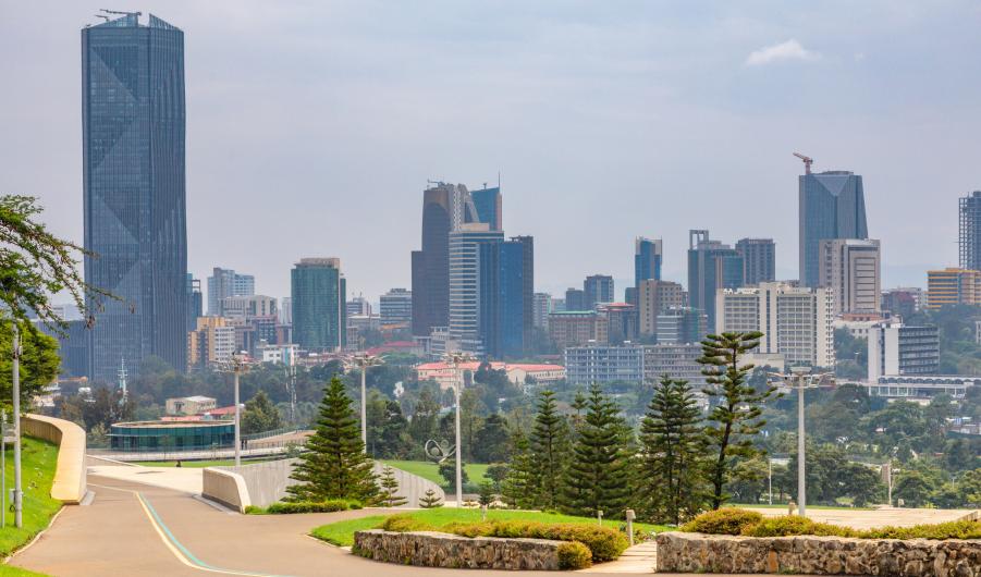 Central business district with modern skyscrapers of downtown of Addis Ababa road and green park in the foreground, Ethiopia stock photo