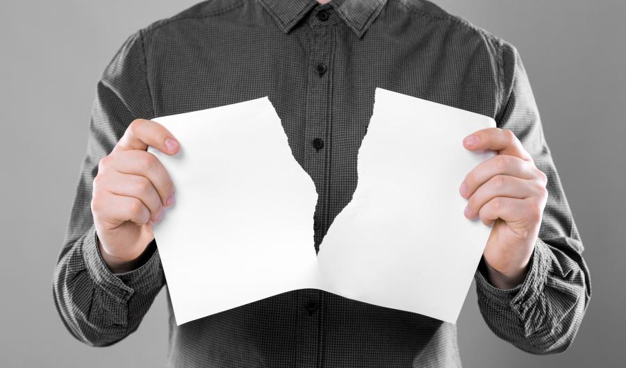 Man ripping sheet of paper 