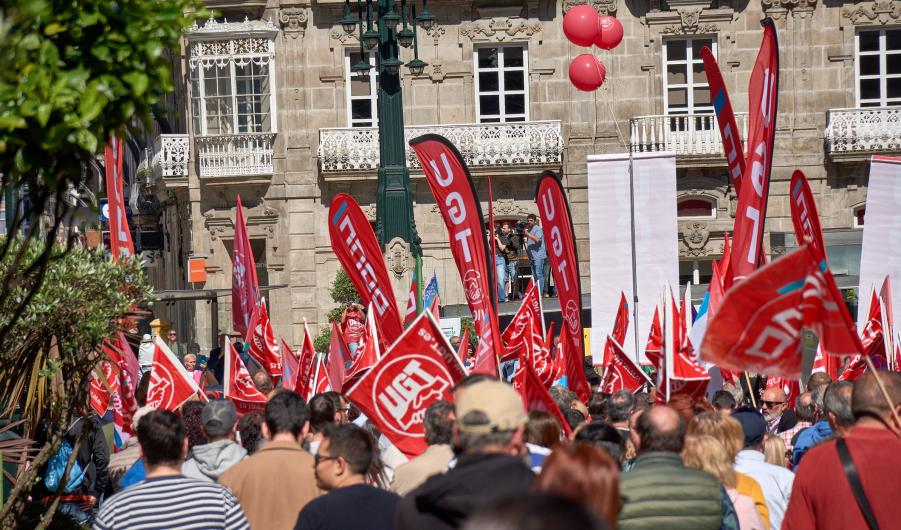 Labor Day demonstration with red flags during May 1st rally in Vigo, Spain